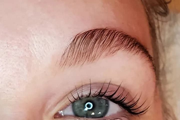 A brushed-up, defined brow above a client's open eye